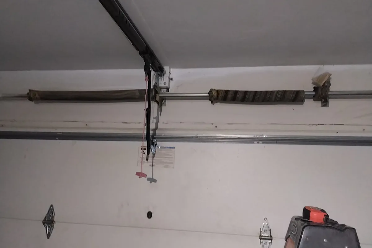 Snapped torsion spring above a residential garage door, one of the most common causes of a sudden breakdown