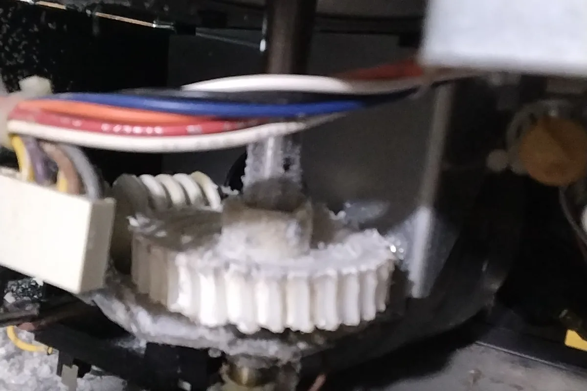 Stripped nylon drive gear inside a garage door opener, a common reason the motor runs but the door does not move
