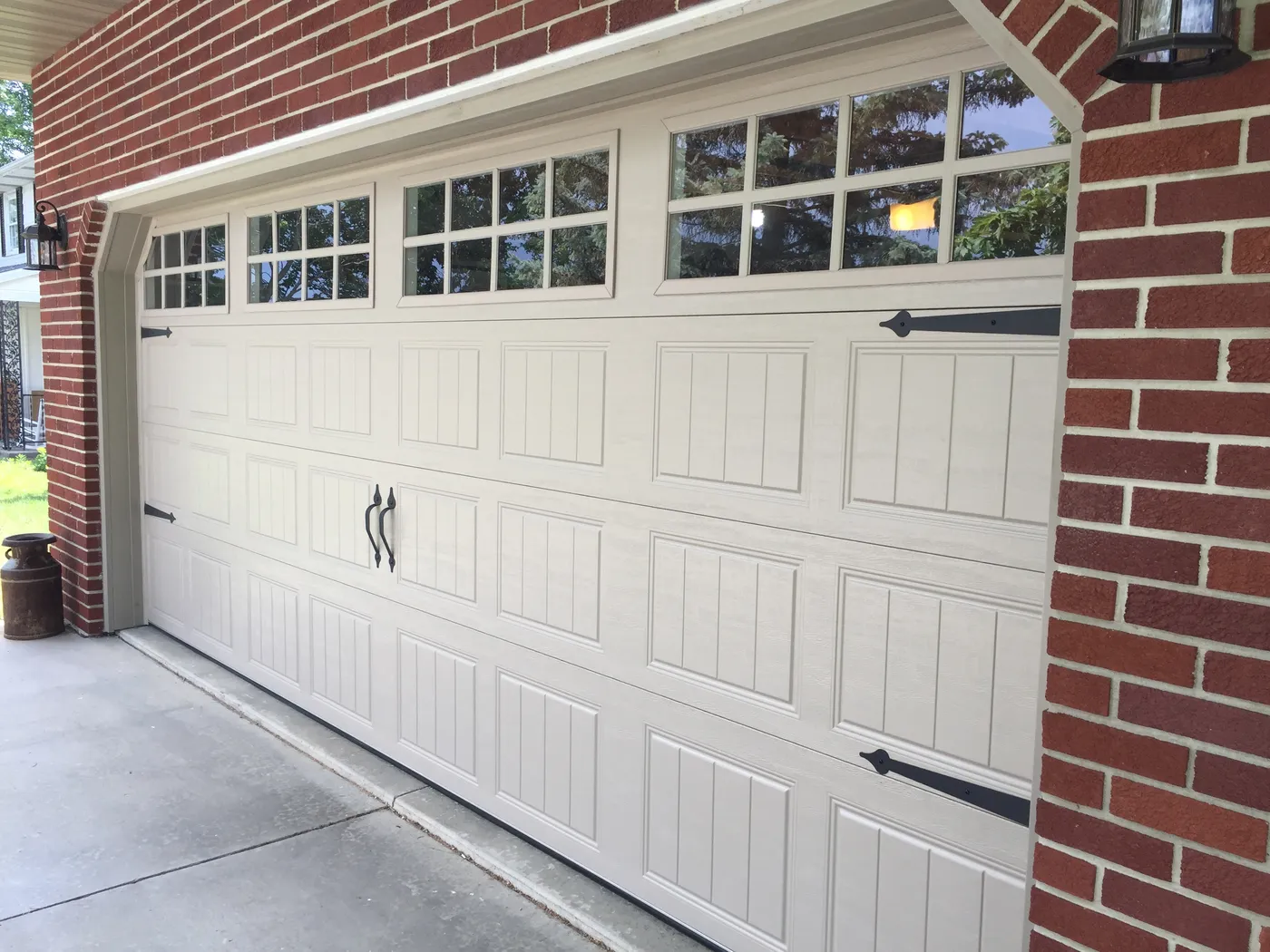 Carriage style door with glazed top row on a brick home